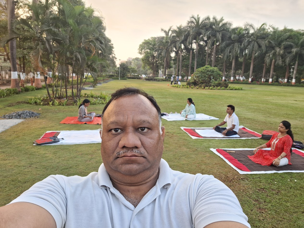Sandeep Vyapari teaching yoga outdoors in the morning
